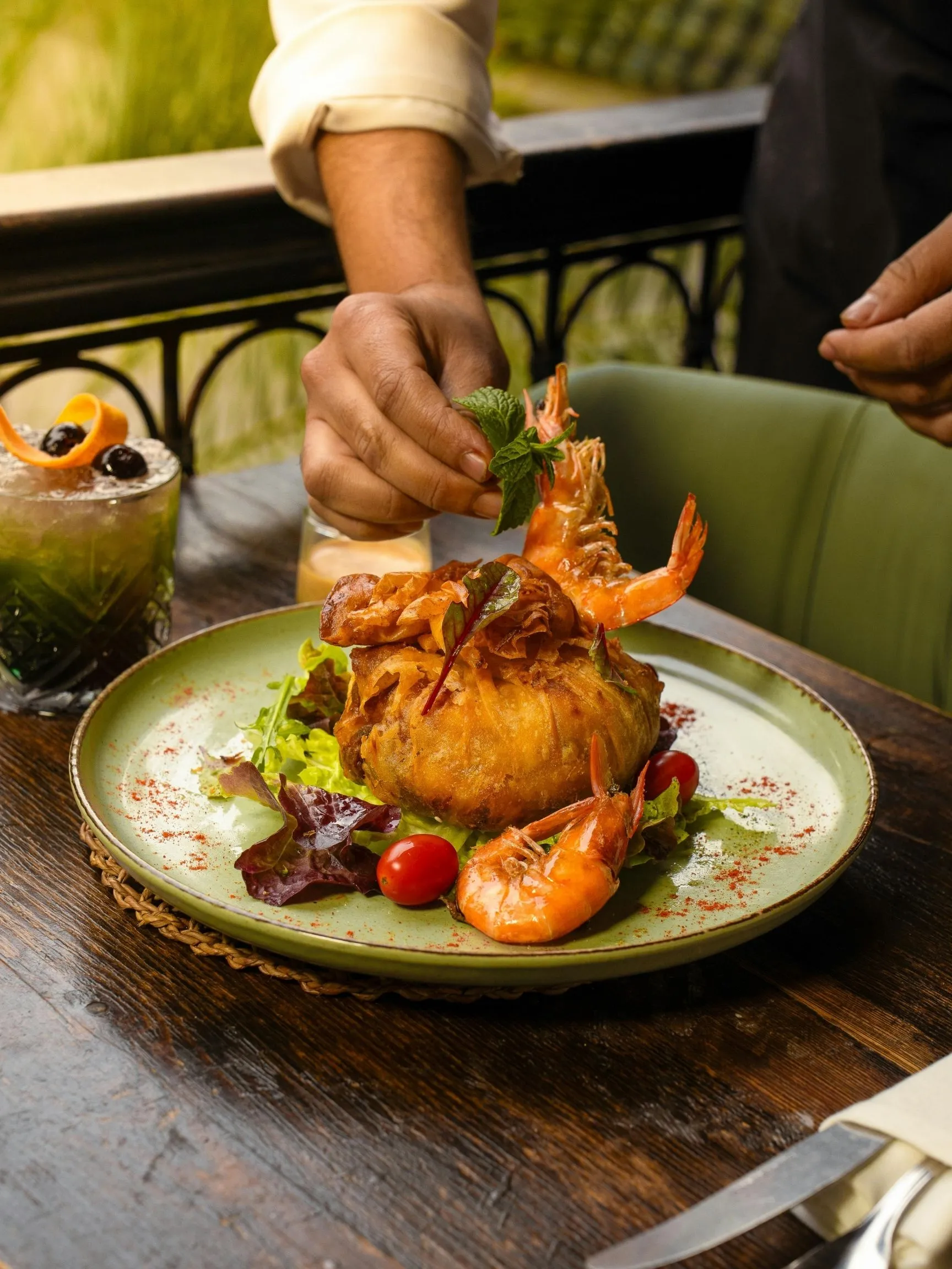 Private chef plating a shrimp starter for a fine dining dinner at home